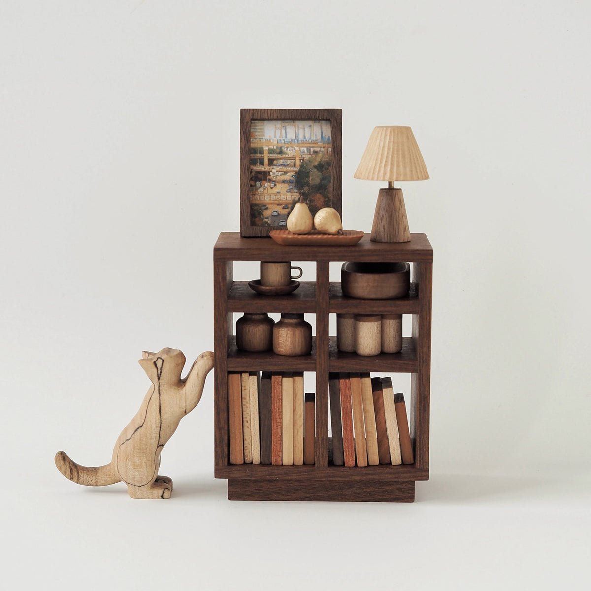 Wooden bookshelf with books and a lamp on a white background