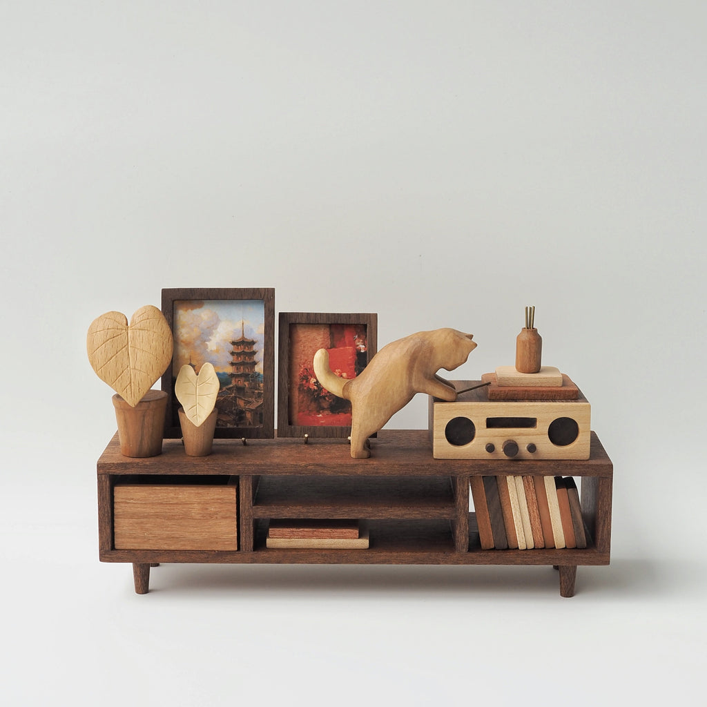 Wooden shelf with decorative items on a white background